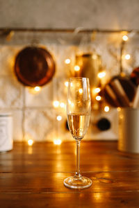 The clinking of glasses with champagne wine against the background of christmas garlands