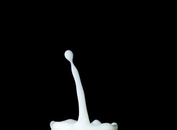 Close-up of cake against black background