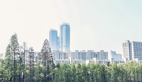 Panoramic view of modern buildings against clear sky