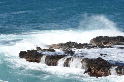 Waves splashing on rocks at shore