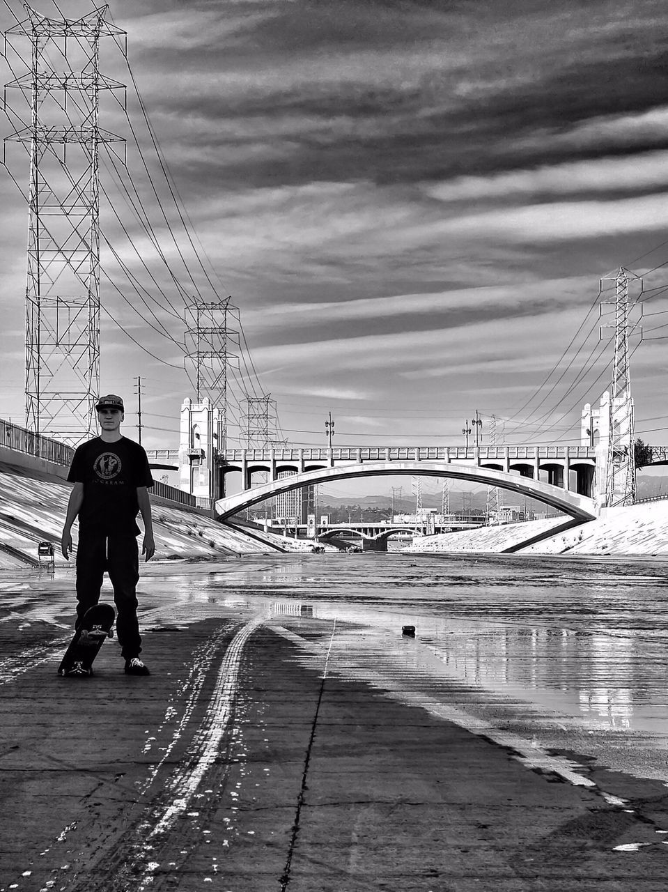 sky, full length, lifestyles, walking, rear view, cloud - sky, leisure activity, men, the way forward, water, cloudy, standing, railing, connection, outdoors, cloud, person, street