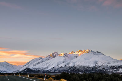 Scenic view of snowcapped mountains against sky during sunset