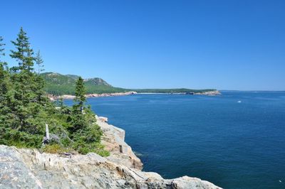 Scenic view of sea against clear blue sky