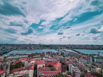 High angle view of townscape by sea against sky