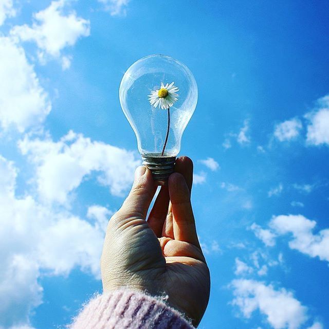 low angle view, sky, blue, cloud - sky, cloud, day, part of, outdoors, nature, person, sunlight, cloudy, holding, leisure activity, white color, beauty in nature