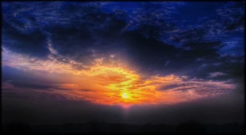 Scenic view of cloudy sky at sunset