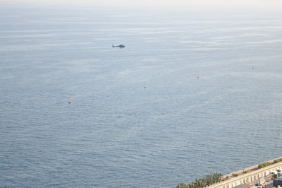 High angle view of birds flying over sea