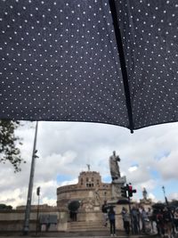 View of wet city against sky during rainy season