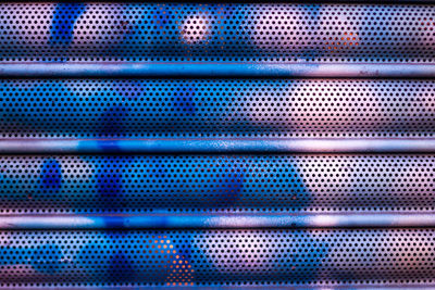 Metal garage shutter painted with abstract shapes 