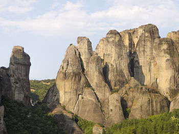 Low angle view of mountains against cloudy sky