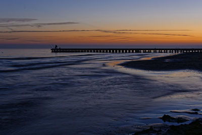 Scenic view of beach against sky during sunset