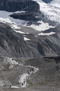 People hiking on mountain during winter