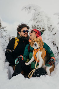 High angle view of  a couple and a dog on snow