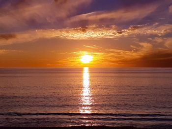 Scenic view of sea against romantic sky at sunset