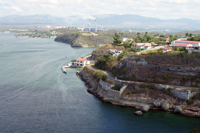 High angle view of sea and cityscape against sky