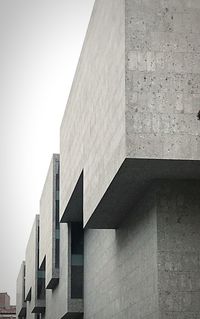 Low angle view of office building against sky