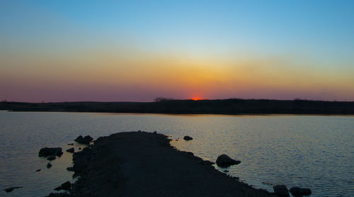 Scenic view of sea at sunset