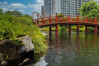 Bridge over river in city against sky