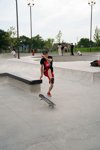 Full length of boy running on skateboard