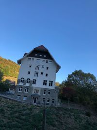 Low angle view of building against clear blue sky