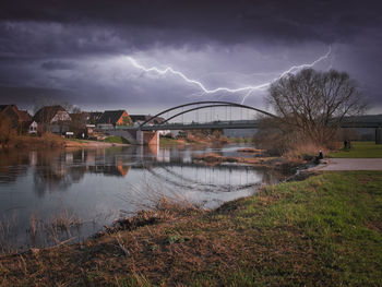 Arch bridge over river against sky