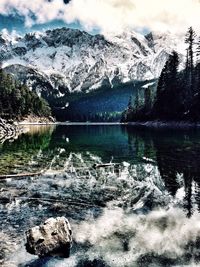Scenic view of lake by trees against sky