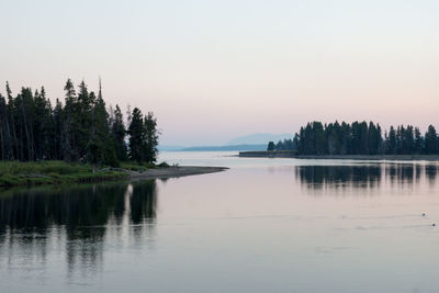 Scenic view of lake against clear sky at sunset