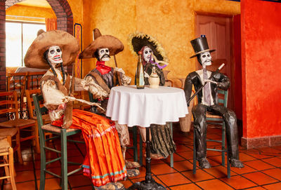 Group of people in front of wooden chairs at home