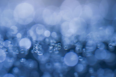 Close-up water bubbling or boiling in clear glass. on a black background.soft focus.