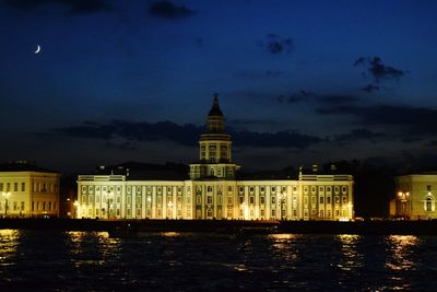Illuminated buildings against sky at night