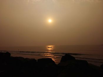 Scenic view of sea against clear sky during sunset