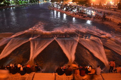 People in illuminated city at night