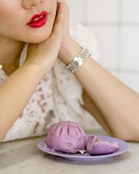 Close-up of woman preparing food on table at home