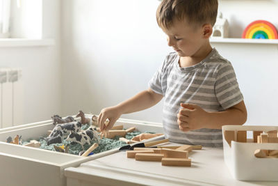 High angle view of boy playing with toy blocks at home