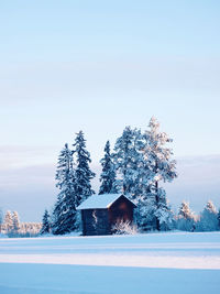 Built structure on snow covered land against sky