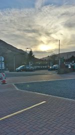 Cars on road at sunset