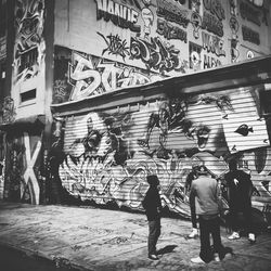 Woman standing in graffiti