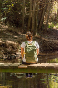 Rear view of woman in front of a forest