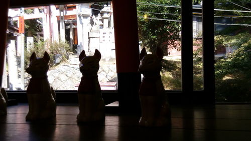 Silhouette people on window sill
