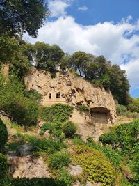 Low angle view of rock formations against sky