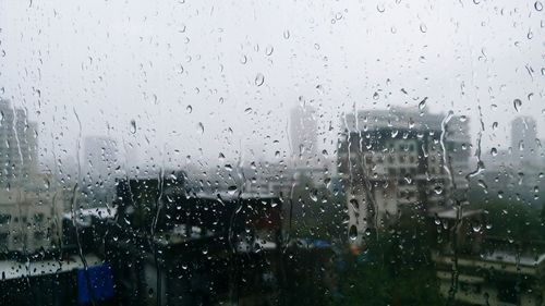 Buildings seen through wet window in rainy season