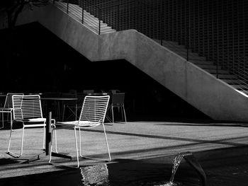 Beautiful light and shadow contrast of street furniture and staircase of a restaurant.