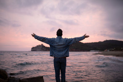 Rear view of man looking at sea