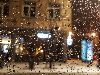 City seen through wet window during rainy season