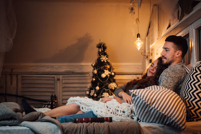 Young couple kissing in bed