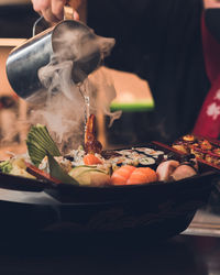 Cropped hand of man preparing food