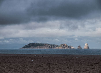 Scenic view of sea against cloudy sky