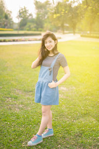 Portrait of smiling girl walking on lawn