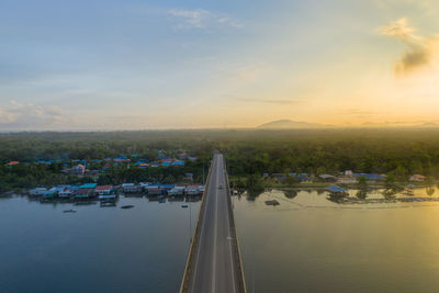 Scenic view of river against sky at sunset