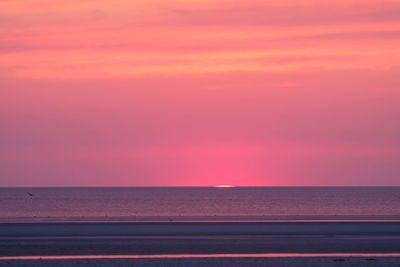 Scenic view of sea against orange sky